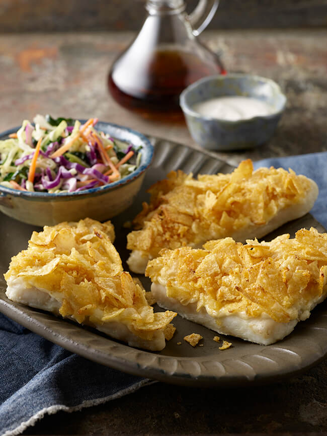 A yummy plate of Wild Alaska Pollock Fish "In" Chips - by that we mean it's breaded with chips! Served with a bowl of cole slaw.