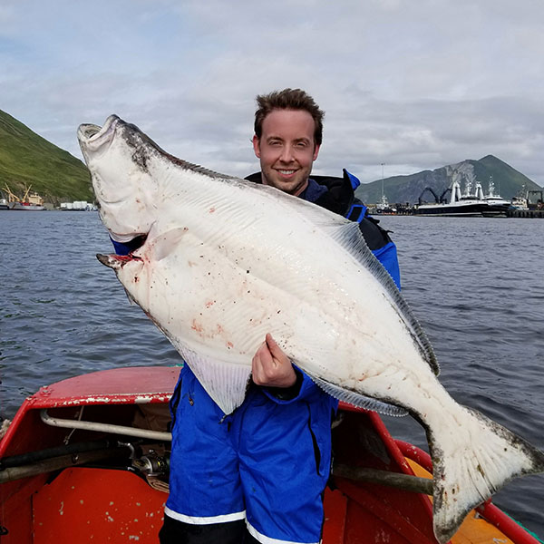 American Seafoods Mate holding large fish